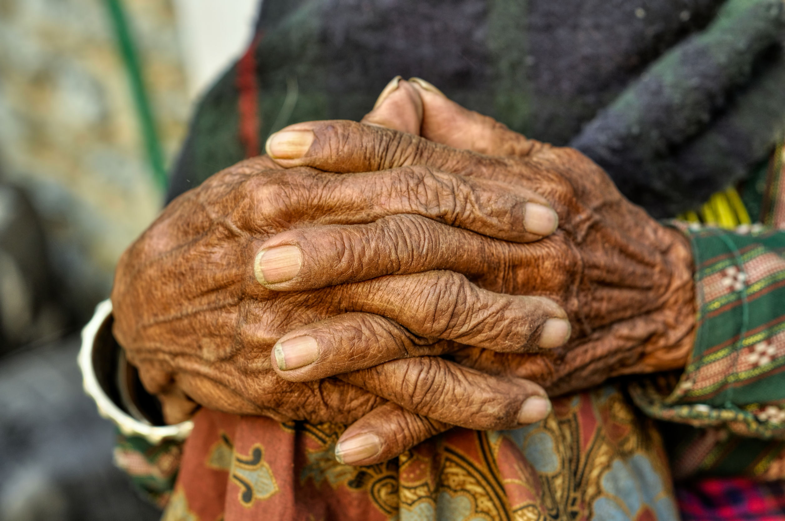 Wrinkled hands of a dark-skinned woman
