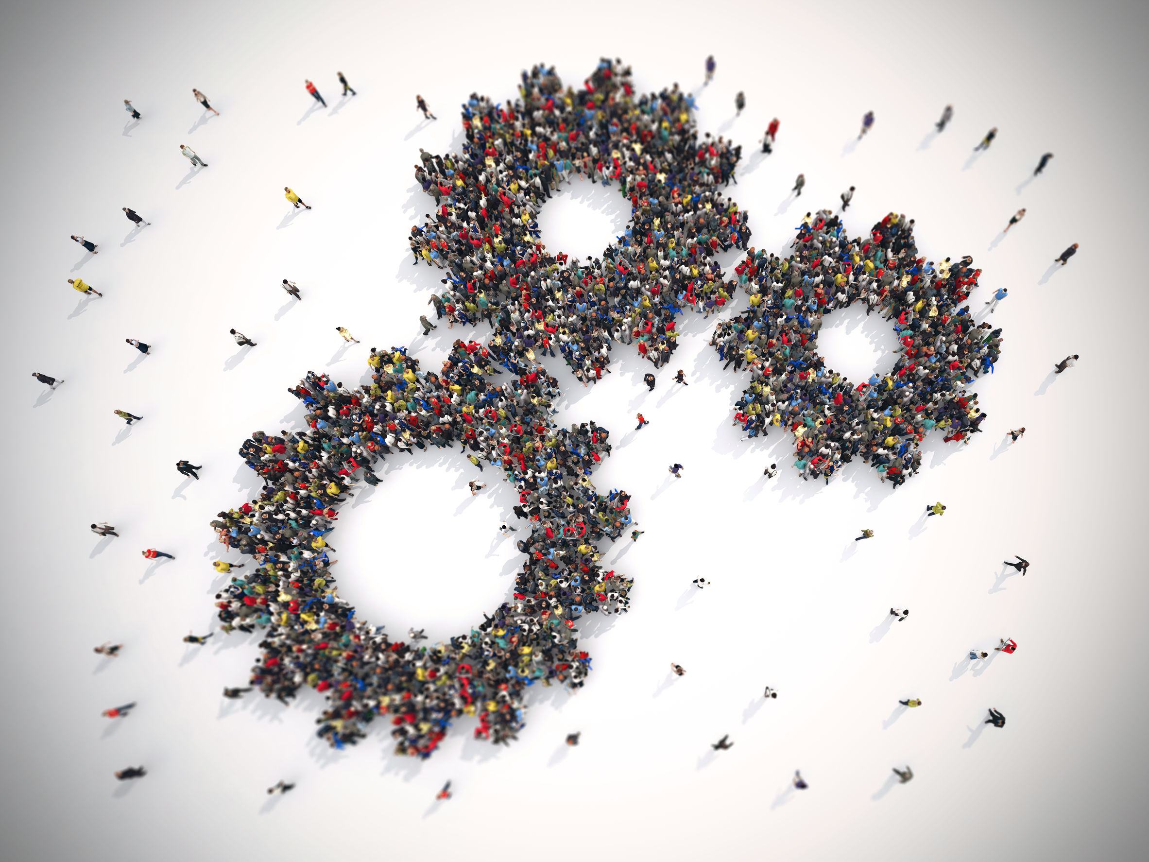 Image of people coming together and forming the shape of three cogs