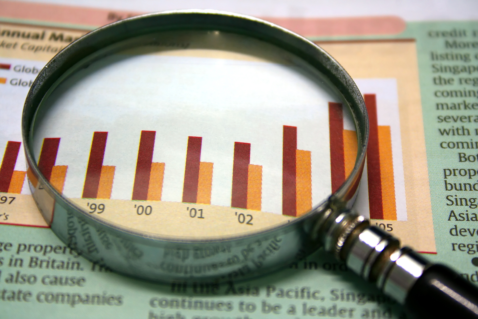 An image of a magnifier over a data table