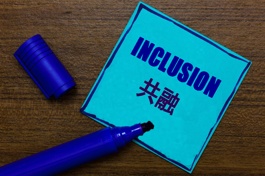 Photo of the word "INCLUSION" written in blue 