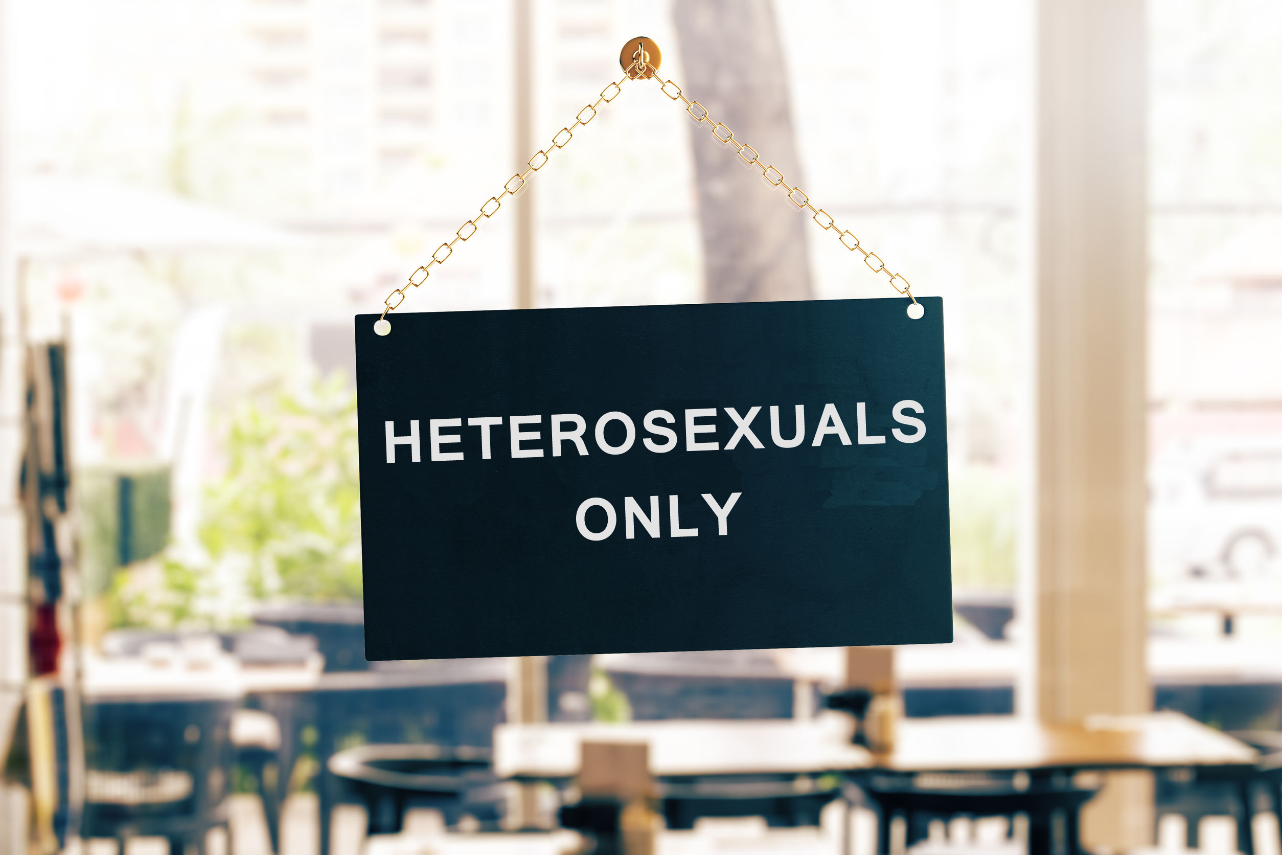 Door sign of a restaurant saying “heterosexuals only” Door sign of a restaurant saying “heterosexuals only”