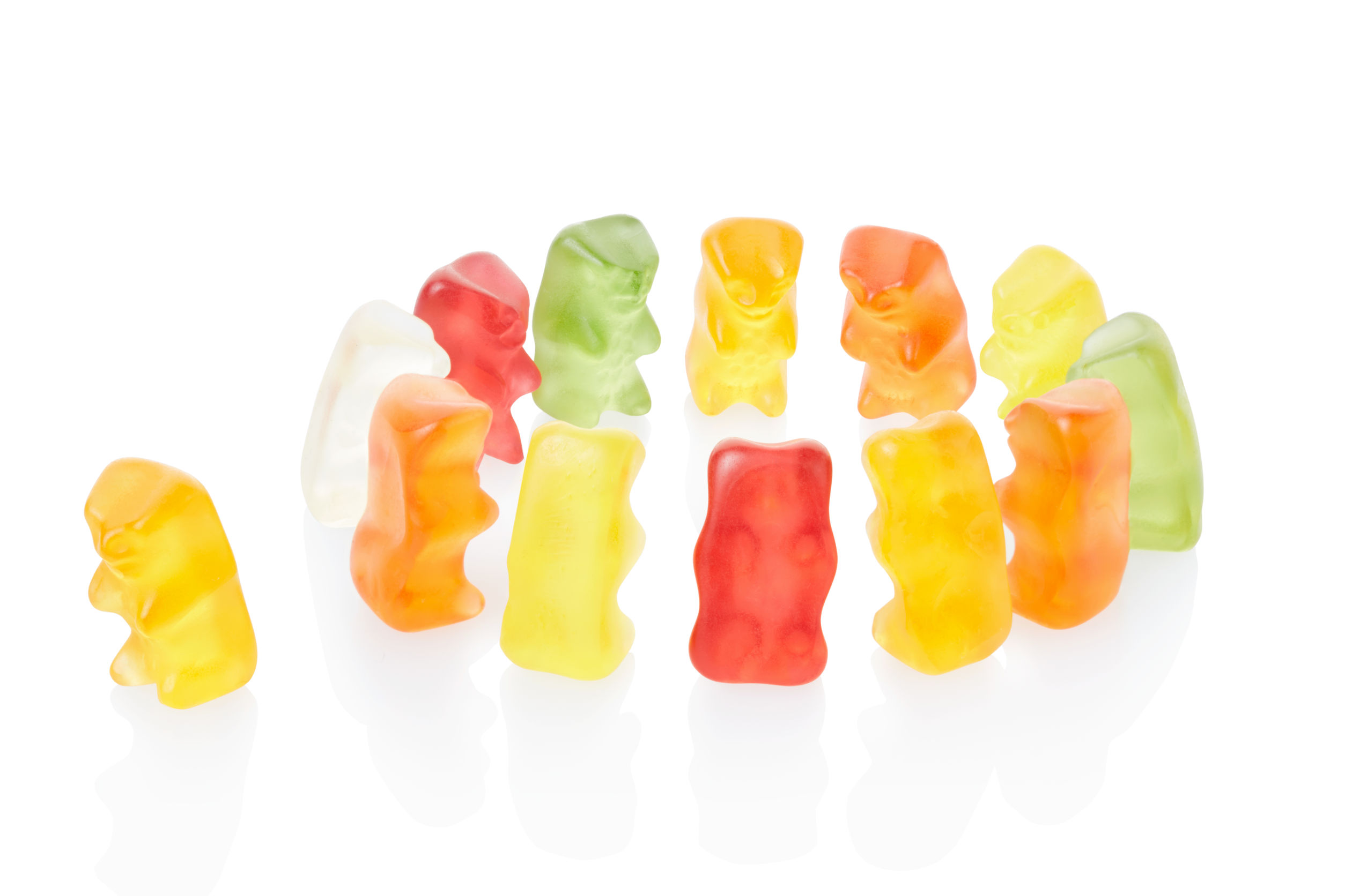Gummy bears forming a circle and shutting out a fellow bear.