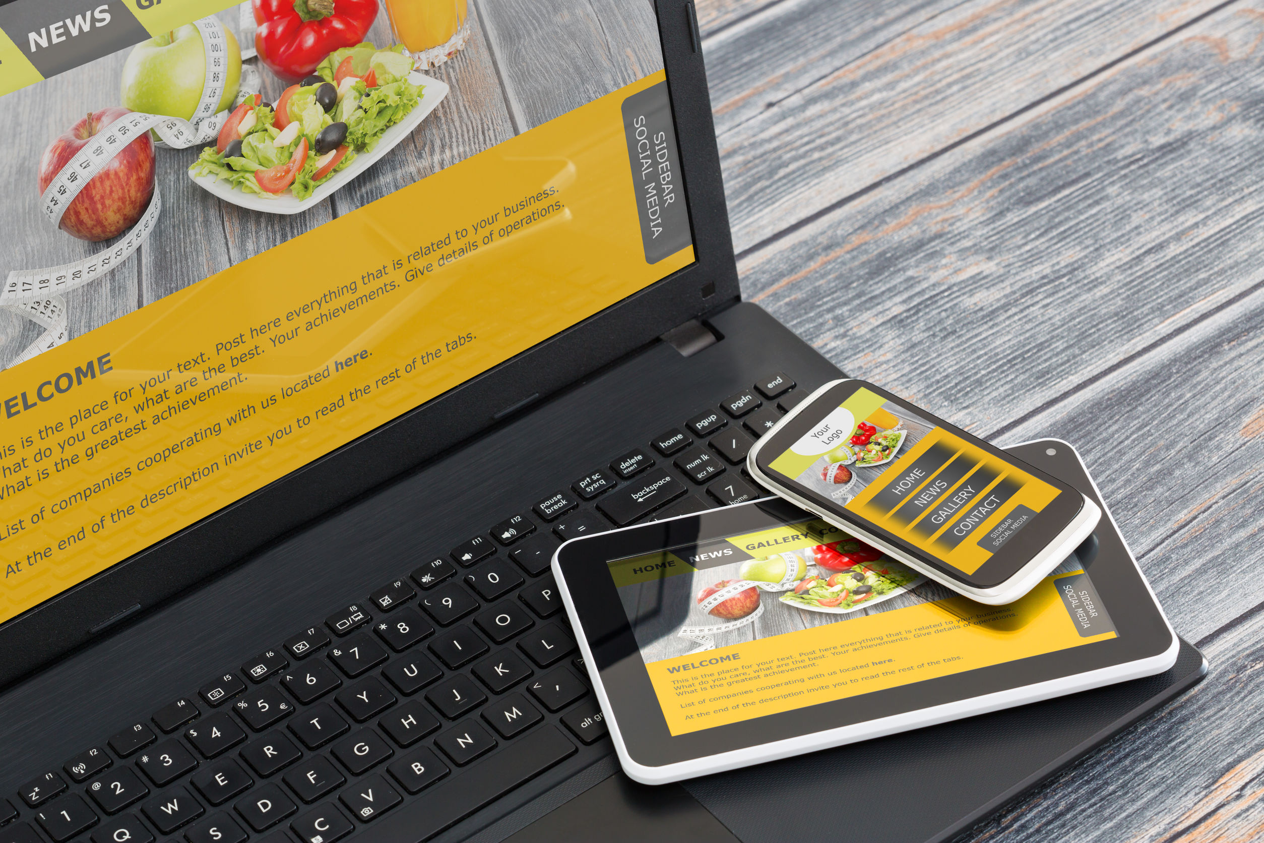 Photo of a laptop, tablet and smartphone showing the same website Photo of a laptop, tablet and smartphone showing the same website