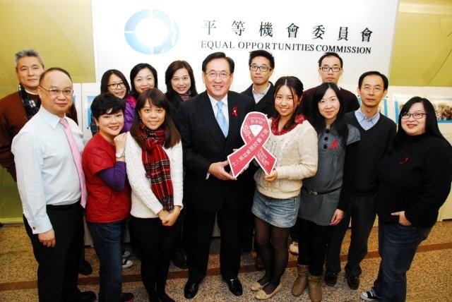 Photo of EOC Chairperson and staff members holding the red ribbon and to fight against HIV stigma and discrimination